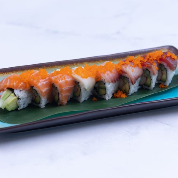 A long platter of Tsukino Sushi Bar's colorful sushi rolls topped with bright orange roe.